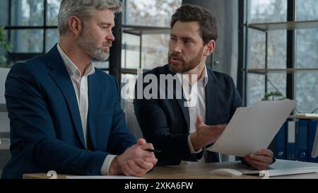 Caucasian men businessmen discussing agreement business documents in office dissatisfied leader employer disappointed with failed contract problem Stock Photo