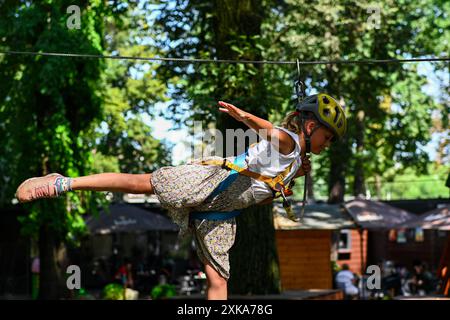 Young adventurer navigating a treetop obstacle course, demonstrating courage and determination. Stock Photo