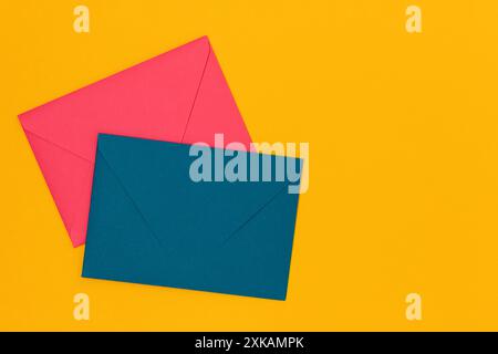 Multicolored envelopes on a yellow background. Composition with place for text. Stock Photo