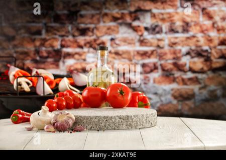 Garlic and red peppers and tomatoes and vegetables on wooden table top and blurred brick wall background. Stock Photo