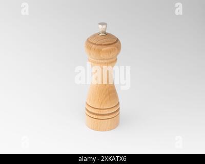 Wooden salt or pepper mill out off beech isolated on white. Manual spice grinder for a kitchen at home. Vintage design of the domestic product. Stock Photo