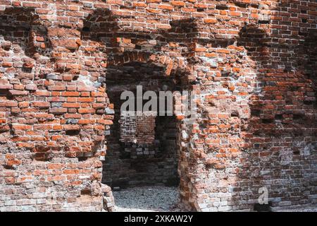 An old dilapidated building of the estate, arched passages made of red brick in perspective. High quality photo Stock Photo