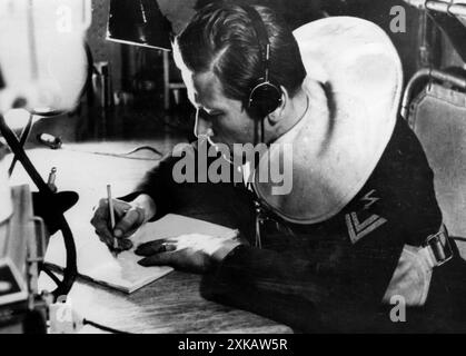 A radio operator on board a speedboat records a radio message. Photo: Weinkauf. [automated translation] Stock Photo