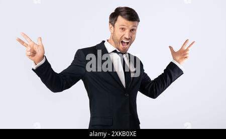 Excited Man Shouting Spreading Hands Standing On White Background Stock Photo