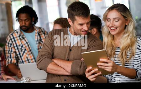 Programmers cooperating at IT company developing apps. People business work office concept Stock Photo