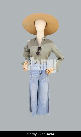 Female mannequin wearing a long-sleeved shirt, jeans and a wide-brimmed hat, Isolate on grey background and have clipping paths. Stock Photo