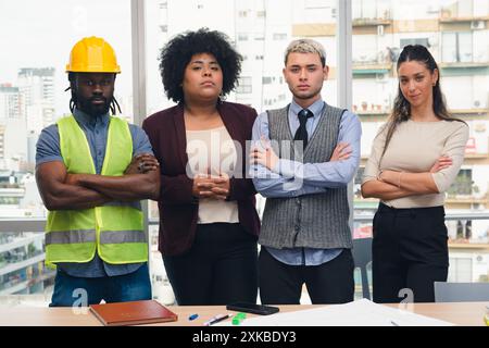 Corporate Portrait of Group of multi ethnic people from construction company in office, they are standing looking at camera posing seriously, there is Stock Photo
