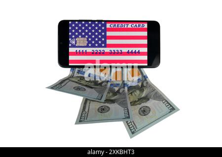 A smartphone with a credit card image in the form of the US flag lies on $100 bills (close-up on a white background) Stock Photo