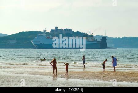 Ro-Ro cargo ship Melusine arriving to the port of Santander passing the Magdalena Palace seen from the beach of Somo Ribamontán al Mar Cantabria Spain Stock Photo