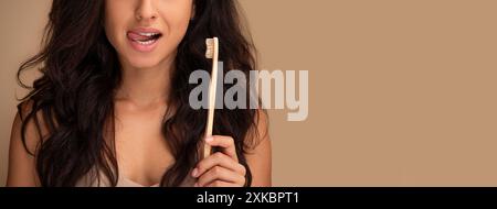 Cropped of brunette young woman holding teeth brush Stock Photo