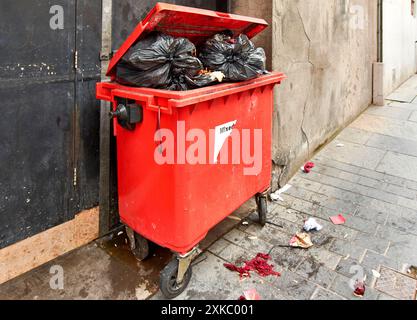 Inverness Scotland red waste bin overflowing with rubbish and food Stock Photo