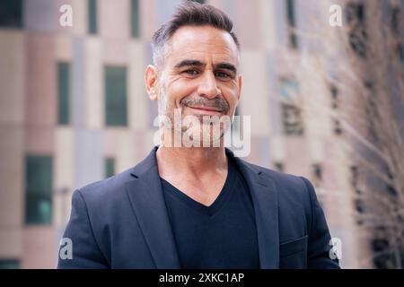 portrait of smiling businessman looking at camera outdoors. Stock Photo