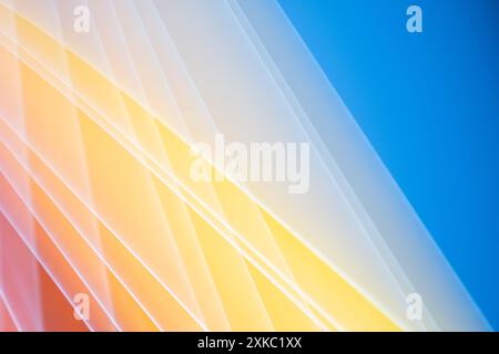 A vibrant background of diagonal yellow stripes against a bright blue backdrop Stock Photo