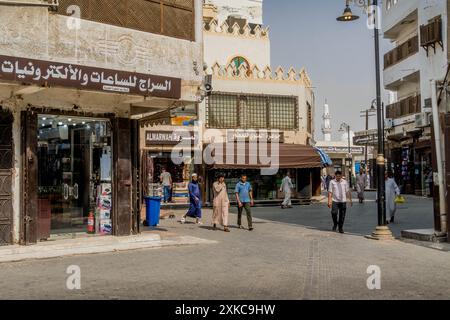 Local Saudi Arabia people on the old streets of historic Jeddah (Al Balad), with the market, shops, stores, and beautiful UNESCO architecture Stock Photo