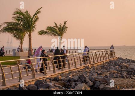 The Saudi people watching sunset on the Al Hamra Corniche in Jeddah waterfront, Saudi Arabia, during the beautiful colorful Middle East sunset. Stock Photo