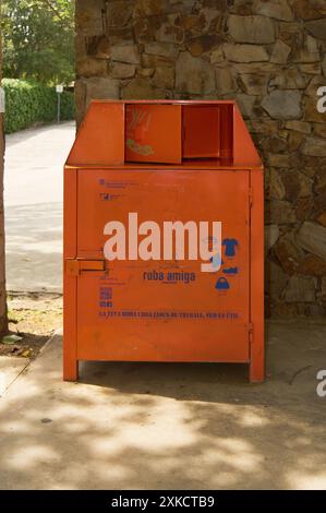 Viladecasn, SPAIN - JULY 22, 2024: Ropa Amiga donation point on a pedestrian path, promoting solidarity and garment reuse. Stock Photo