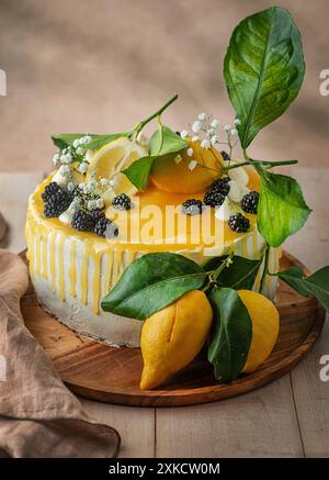 Lemon cake, beautifully decorated with lemons and leaves. Birthday, Wedding cake. Stock Photo