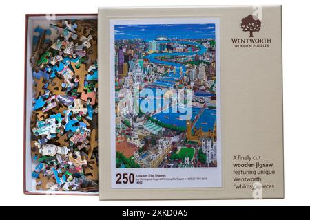 Wentworth Wooden Puzzles box containing puzzle pieces with lid off  - a finely cut wooden jigsaw featuring unique Wentworth whimsy pieces Stock Photo