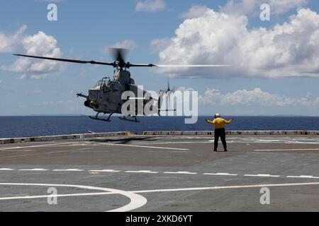 U.S. Navy aviation boatswain’s mate handler Christina ArredondoLopez, assigned to the amphibious transport dock ship USS Green Bay (LPD 20), guides a Stock Photo