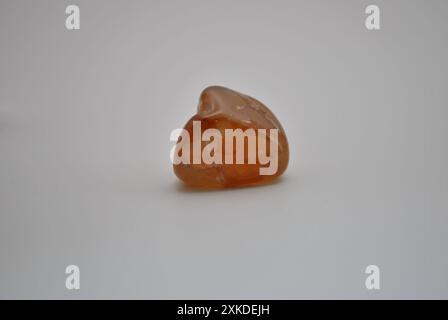 Smooth Tumbled Tangerine Quartz on White Background Stock Photo