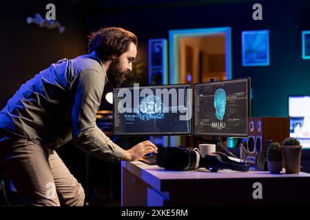 Man typing on keyboard, talking with AI becoming sentient and asking questions about itself. Programmer chatting with artificial intelligence wishing to befriend humanity after becoming self aware Stock Photo