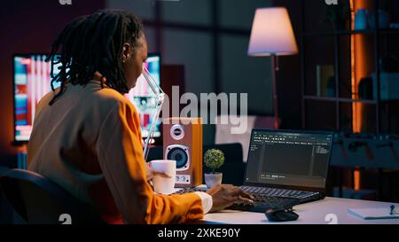 African american IT student practicing coding or programming exercises, learning hardware language and system debugging. Young woman studying database script on html window. Camera A. Stock Photo