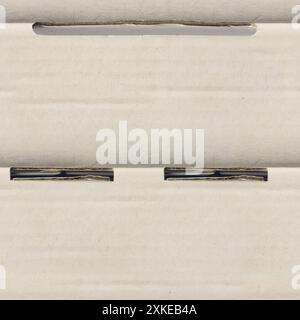 Seamless 4k photo texture of cardboard paper with seams and holes. Stock Photo