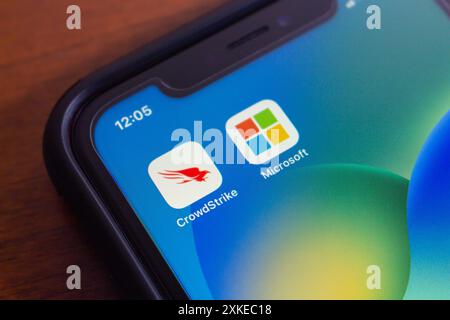 Vancouver, CANADA - Jul 22 2024 : CrowdStrike and Microsoft icons seen in an iPhone. On July 19, 2024, a CrowdStrike Windows sensor update caused glob Stock Photo