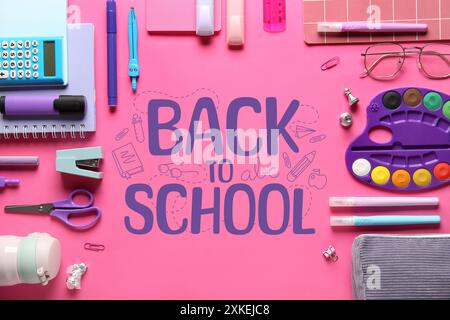 Different stationery and text BACK TO SCHOOL on pink background Stock Photo