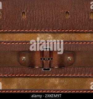 Seamless 4k photo texture photo of brown colored leather perforated belts with metal buckle harness on brown leather material surface with stitching. Stock Photo