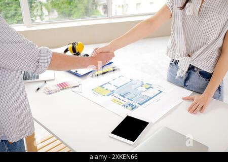 Male contractor with client shaking hands in room, closeup Stock Photo