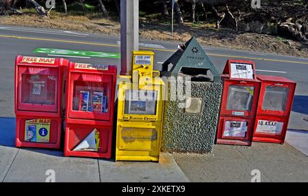 newspaper and advertising boxes on a sidewalk in San Francisco, California Stock Photo