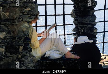 Woman reading at the coast of Monterosso Al Mare Cinque Terre,  Italy Stock Photo