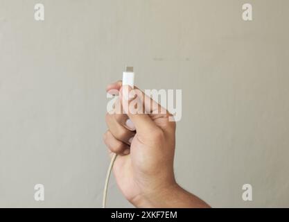Close up Man hands holding usb-c cord Stock Photo