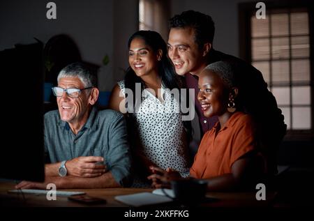 Creative, team and happy in office at night with computer for creating blog post, online and developing content strategy. Copywriter, group and Stock Photo