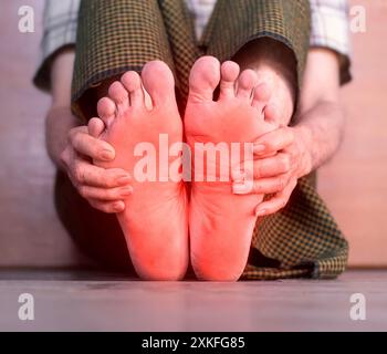 Tingling and burning sensation in foot of Asian elder man with diabetes. Foot pain. Sensory neuropathy problems. Foot nerves problems. Plantar fasciit Stock Photo