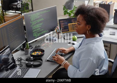 Lines of code running on computer screens in data center providing ...