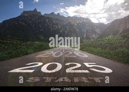 2025, the new year 2025 or the beginning of the concept of the word 2025, written on a road in the middle of a paved road with a sunset mountain backd Stock Photo