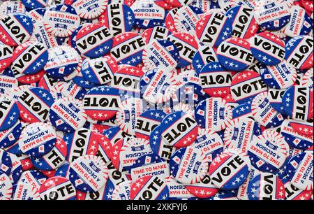A pile of red, white, and blue "Vote" buttons encouraging decision-making and participation in the election process in 3D illustration Stock Photo