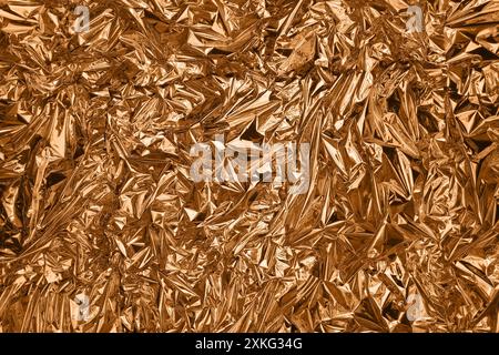 Fullframe crumpled copper foil shining texture background. Stock Photo