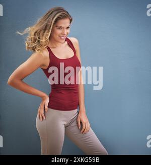 Studio, woman and happiness with pride for carefree, healthy hair and ready for dance class. Blue background, female person or cardio dancer with Stock Photo