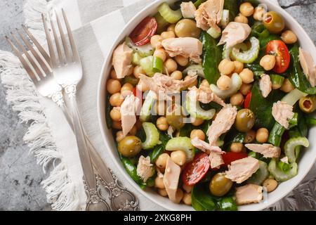 Chickpea tuna salad that's filled with bright flavor and fresh ingredients like tomatoes, celery, spinach and homemade dressing close-up in a bowl on Stock Photo