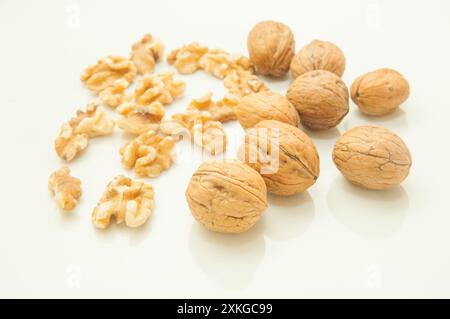 walnuts with and without shell, on white background. Stock Photo