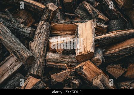 Stacked Firewood, essential for warmth and survival, adds a rustic touch to the outdoors in winter Stock Photo
