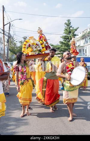 Devout Hindu worshippers march to the Arya Spiritual Grounds for the Thimithi ritual of walking on hot coal. In Jamaica, Queens, New York. Stock Photo