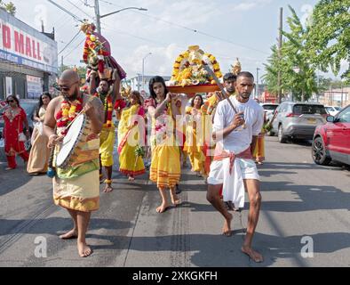 Devout Hindu worshippers carrying a statue of goddess Kali march to the Arya Spiritual Grounds for the Thimithi ritual. In Jamaica, Queens, New York. Stock Photo