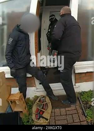 EDITORS NOTE IMAGE BLURRED AT SOURCE Screen grab taken from body worn video dated 17/07/23 issued by Metropolitan Police of police officers arresting Anjem Choudary at his home. Choudary has been found guilty at Woolwich Crown Court of directing the terrorist organisation Al-Muhajiroun and encouraging support for it through online meetings. Issue date: Tuesday July 23, 2024. Stock Photo