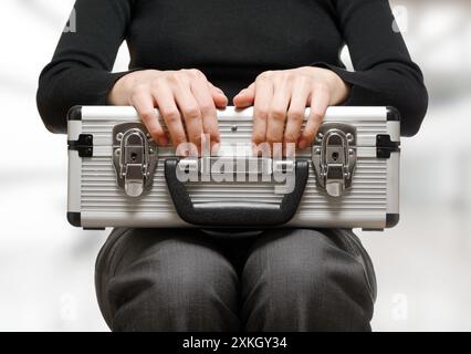 Business woman holding an aluminium briefcase Stock Photo