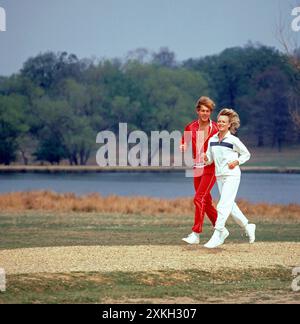 Young couple running in a park. Stock Photo