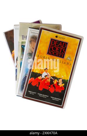 stack pile of VHS video cassette tapes with Dead Poet's Society video cassette tape on top isolated on white background - starring Robin Williams Stock Photo